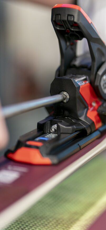 Detailaufnahme einer Skibindung im Skiverleih Hauser Kaibling, die mit einem Schraubenzieher justiert wird. Der Fokus liegt auf der präzisen Anpassung der Bindung an den Skischuh. | © Klaus Pressberger
