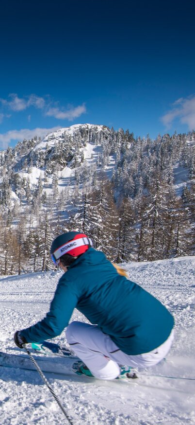 Eine Frau fährt gerade auf der Fageralm die Piste hinunter. | © Lorenz Masser