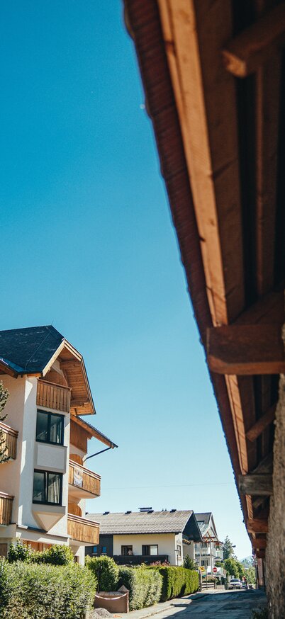 großes Hotel mit Hozldetails an Dach und Balkone, schöner blauer klarer Himmel | © © Christine Höflehner