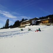 Kids snowtubing at Rösteralm in Vorberg