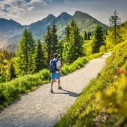 A hiker walking along Planai Panorama Loop